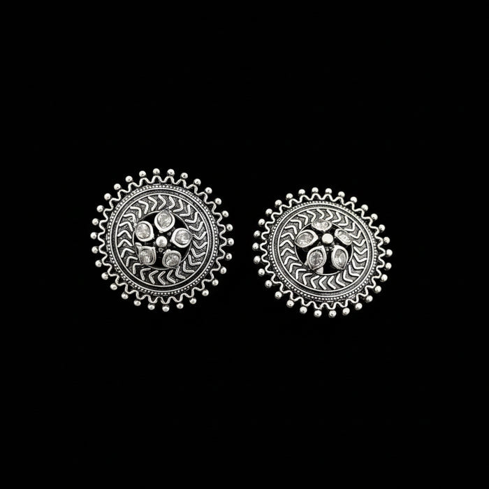 Pair of silver earrings on a gray background