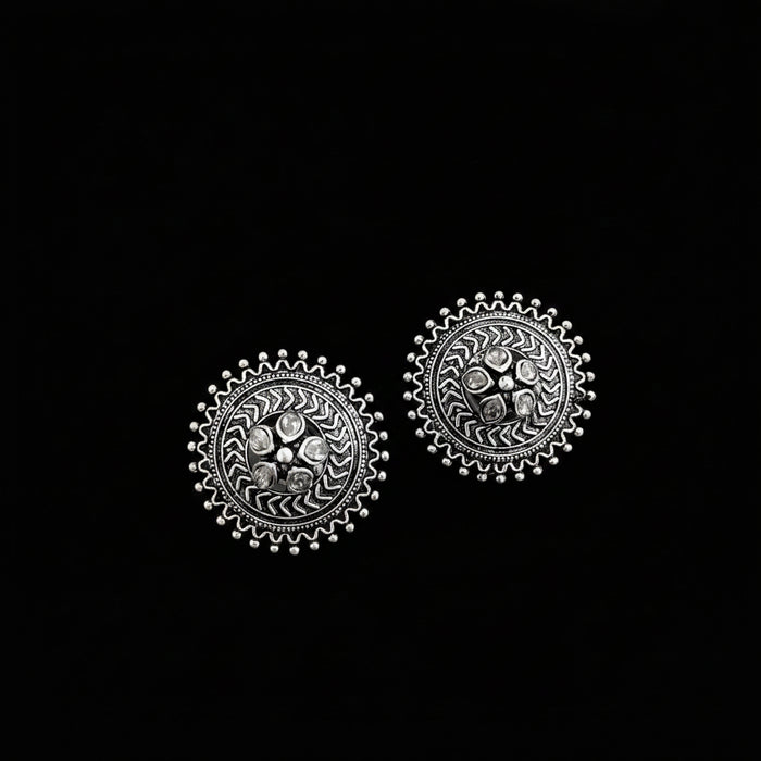 Pair of silver earrings on a gray background