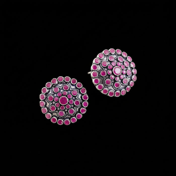 Pair of pink and silver earrings on a gray background with 'Saheli' branding.