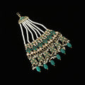 Ornate necklace with green and gold details on a dark background, featuring the brand 'Saheli'.