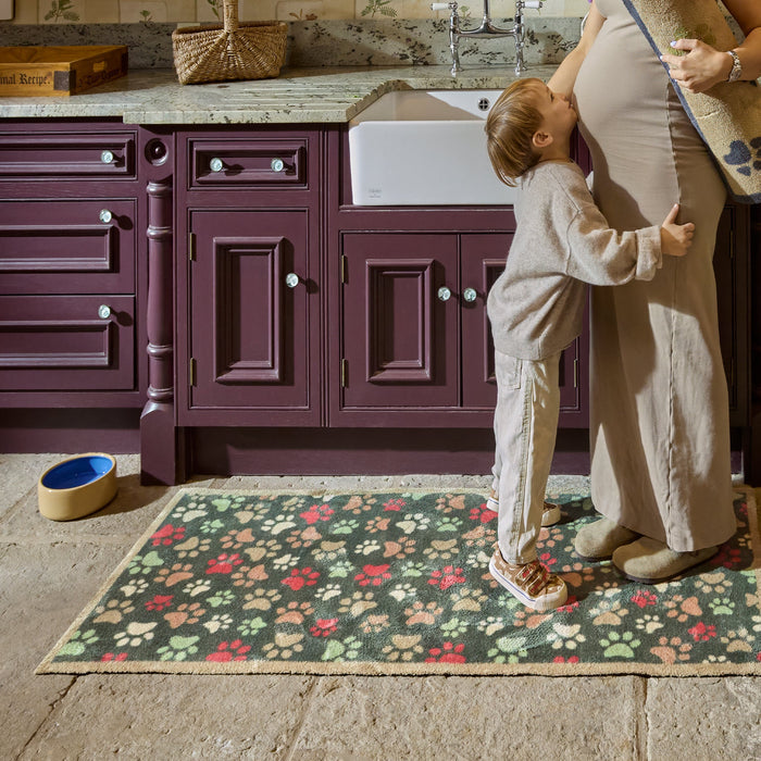Paws for Love Washable Runner in Green- a 100% recycled cotton runner featuring multi-coloured paw prints in a multi-directional pattern.