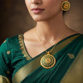 Gold and green jewelry set with 'Saheli' branding on a black background