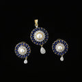 Jewelry set with pendant and earrings on a black background, featuring the brand 'Saheli'.
