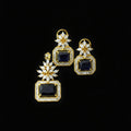Gold and black earrings with 'Saheli' branding on a dark background