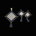 Pair of blue and gold earrings on a gray background with 'Saheli' branding.