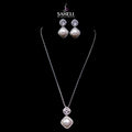 Jewelry set with necklace and earrings on a black background, featuring the brand 'Saheli'.