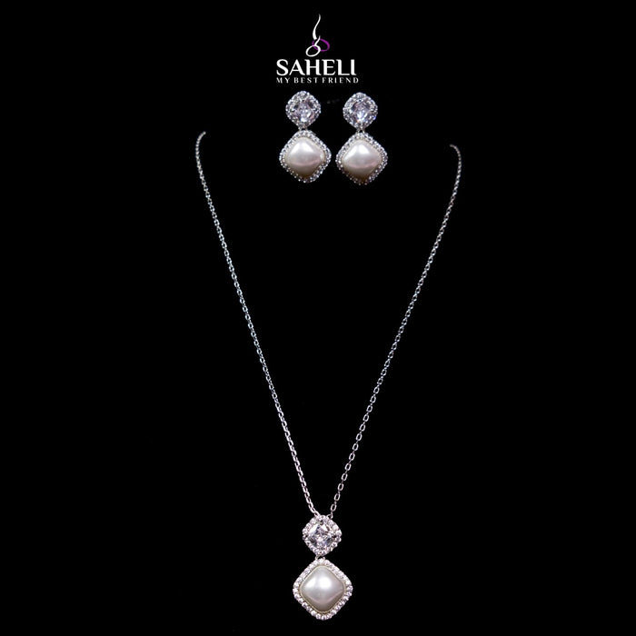 Jewelry set with necklace and earrings on a black background, featuring the brand 'Saheli'.