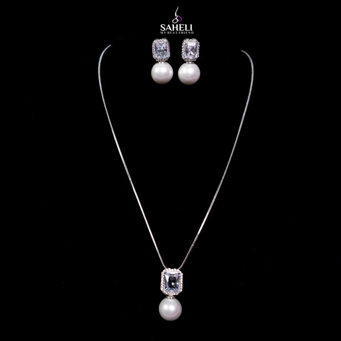 Jewelry set with necklace and earrings on a black background, featuring the brand 'Saheli'.
