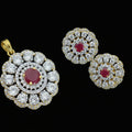 Gold and diamond earrings with red gemstones on a dark background, featuring the brand 'Saheli'.