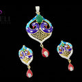 Colorful jewelry set with pendant and earrings on a dark background, featuring the brand 'SAHELI'.