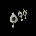 Diamond earrings with black stones on a dark background, branded 'Saheli'.
