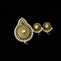 Gold and pearl earrings with blue stones on a dark background, branded 'Saheli'.
