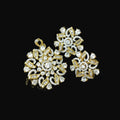 Gold and diamond earrings on a dark background with 'SAHELI' branding.