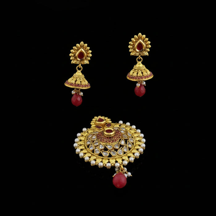 Gold earrings with red and pearl accents on a dark background, featuring the brand 'SAHELI'.