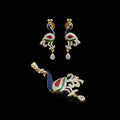 Peacock-shaped earrings and pendant with 'SAHELI' branding on a gray background