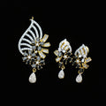 Ornate earrings with gemstones on a dark background, featuring the brand 'Saheli'.