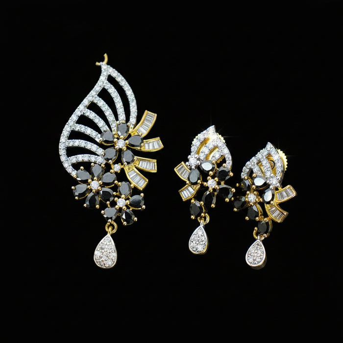 Ornate earrings with gemstones on a dark background, featuring the brand 'Saheli'.