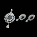 Jewelry set with earrings and a pendant on a dark background, featuring the brand 'Saheli'.