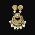 Gold and pearl earrings on a black stand with 'SAHELLI' branding.