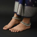 Silver bracelet with pearl-like beads on a dark background