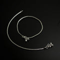 Silver necklace with pendant on a dark background