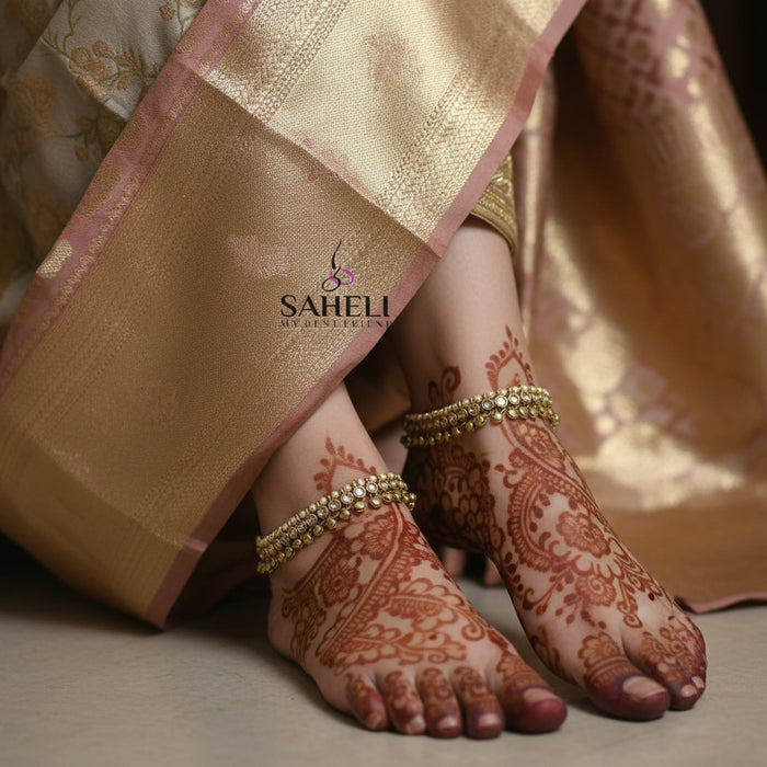 Gold necklace and bracelet set with 'Saheli' branding on a dark background