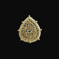 Gold and silver teardrop-shaped jewelry piece on a dark background