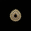 A gold-toned floral brooch featuring a central black teardrop-shaped stone surrounded by clear marquise and round crystals, displayed on a dark reflective surface with the SAHELL MY BEST FRIEND logo in the top left corner.