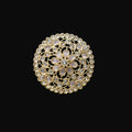 Gold ring with intricate design on a black mannequin hand against a dark background