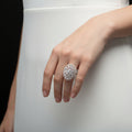 Diamond ring on a reflective surface with 'SAHELL' branding.