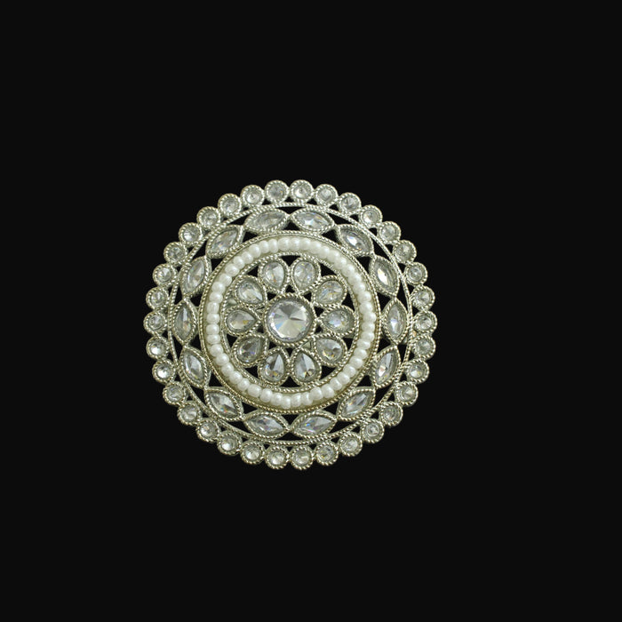 Decorative circular object with intricate design on a black background