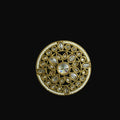 Decorative circular object with gold and gemstone design on a black background