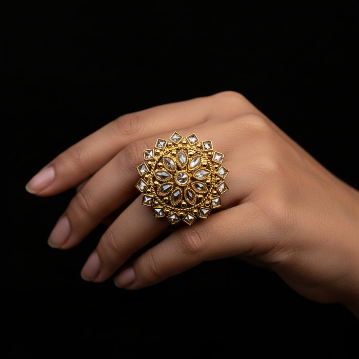 A large ornate gold ring with clear stones is displayed on a black velvet hand against a black background, with the text 'SAHELI MY BEST FRIEND' centered above the hand.