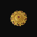 Gold ring with red gemstones on a black mannequin hand against a dark background