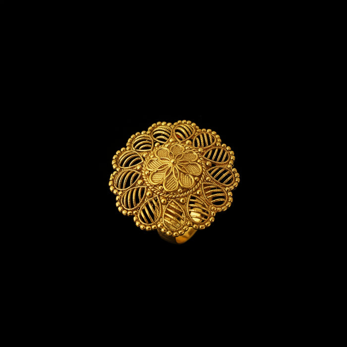 A gold filigree ring with a circular mandala-like floral design, displayed on a black hand against a dark gray background. The brand logo 'SAHELI JEWELLERY' is visible in the top left corner.