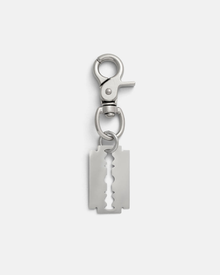 The Razor Blade Belt Clip features a stainless steel razor blade pendant and a sturdy clasp, ideal for alternative fashion enthusiasts. Presented on a plain white background.