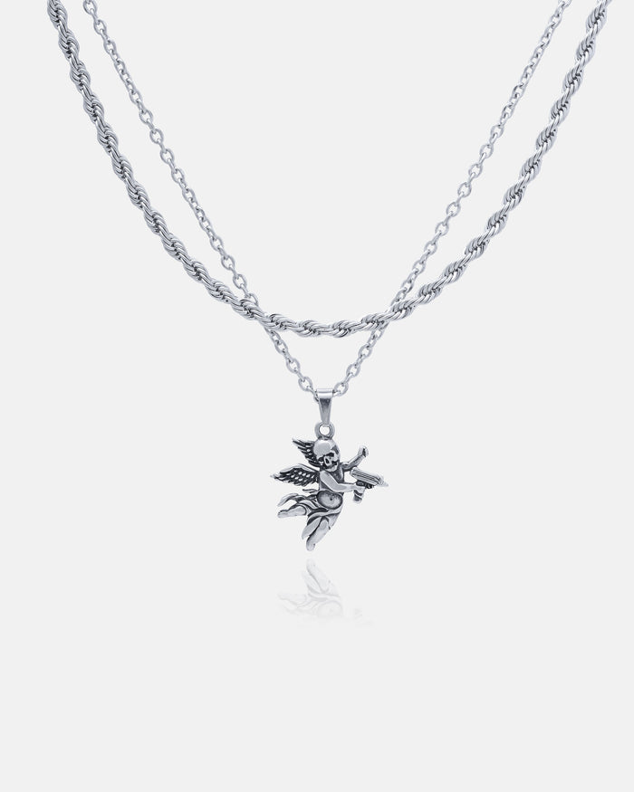 The Statement Collective Rope Set features a silver double-chain necklace with a custom pendant choice, shown here as a detailed angel holding a star. Stainless steel, hypoallergenic, and set against a white background for contrast.