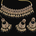 Jewelry set with necklace and earrings on a dark background, featuring the brand 'Saheli'.