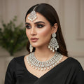 Silver necklace set with pendants on a dark background