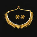 Gold necklace and earrings set with pearls on a gray background, featuring the brand 'Saheli'.