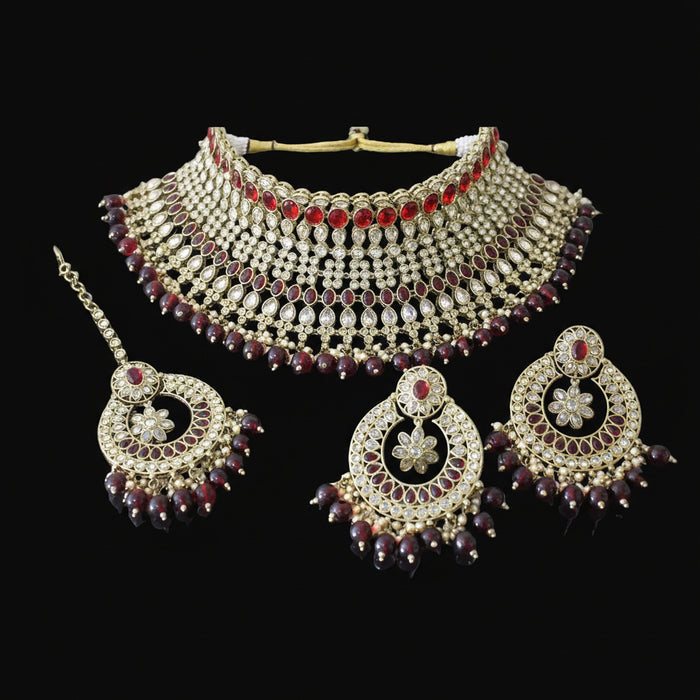 Jewelry set with necklace, earrings, and hair accessories on a dark background