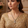 Jewelry set with necklace and earrings on a black background, featuring the brand 'Saheli'.
