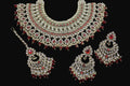 Ornate necklace set with red stones on a dark background