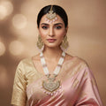 Ornate necklace with matching earrings on a dark background