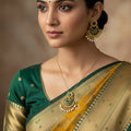 Gold and green earrings with pearls on a dark background, branded 'Saheli'.