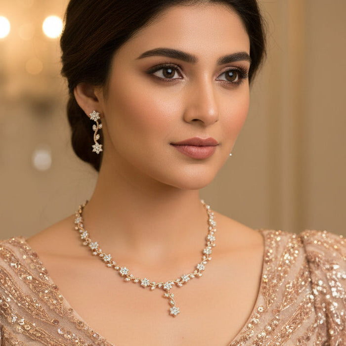 Gold and diamond necklace and earrings on a black background