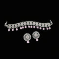 Jewelry set with necklace and earrings on a dark background, featuring the brand 'Saheli'.