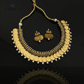 Gold coin necklace and matching gold coin earrings with white pearl accents, displayed on a dark gray reflective surface. The Saheli My Best Friend logo is visible in the top left corner.
