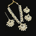 Pearl necklace and earrings set with 'SAHELI' branding on a dark background
