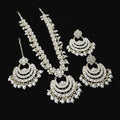 Set of gold and pearl jewelry on a dark background
